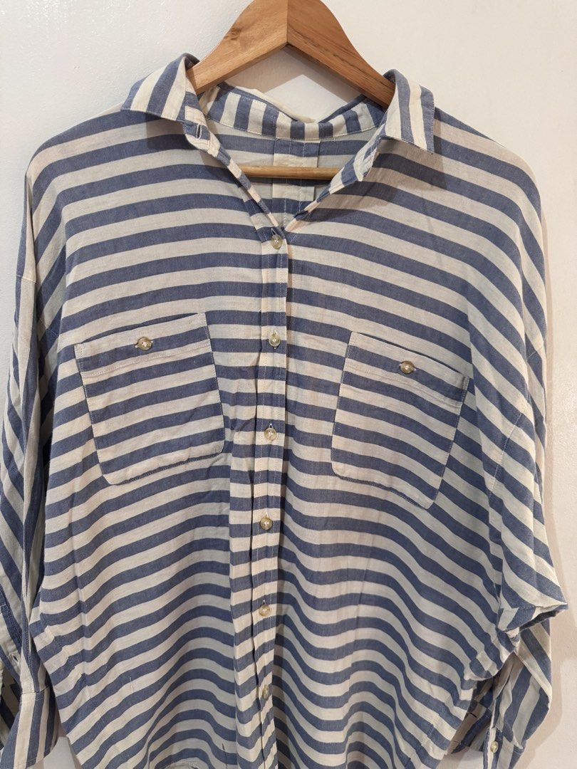 Oversized Striped Button Up Shirt (Category: Blouses) located in Quezon City. Submitted by vibelane_shop (Listing ID 1467427790, Image 3). Description: - Classic blue and white striped pattern - Relaxed, oversized fit with a curved hem - Button-down front featuring a collar and two chest pockets - Soft and lightweight material for all-day comfort - Versatile piece, easy to style with denim or trousers ************ 📝This is not an online store of