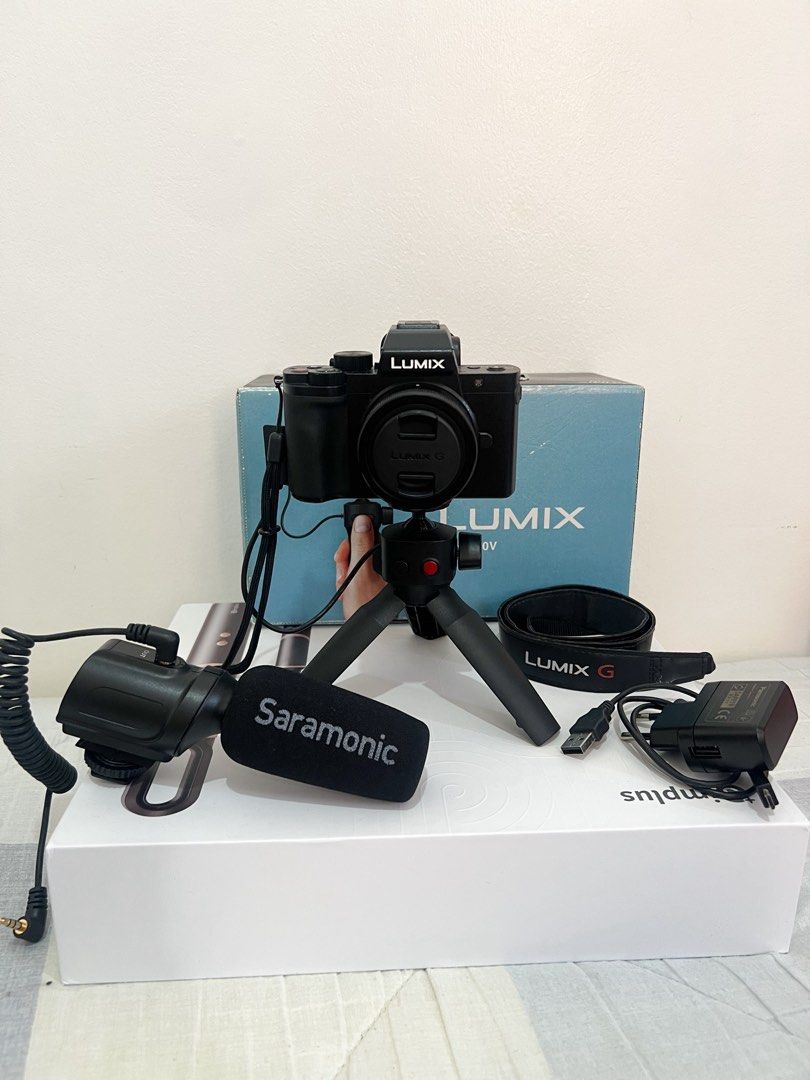 Panasonic Lumix G100V Mirrorless Camera Kit (Category: Cameras) located in San Jose del Monte. Submitted by joy_ochoa (Listing ID 1467403980, Image 1). Description: Panasonic Lumix DC-G100V mirrorless camera bundled with 12-32mm lens, tripod grip, Saramonic external microphone, strap, power adapter, and USB cable. Original box included. Fully operational with screen powered on. No issues. Bought from CameraHaus SM North for 44,000.