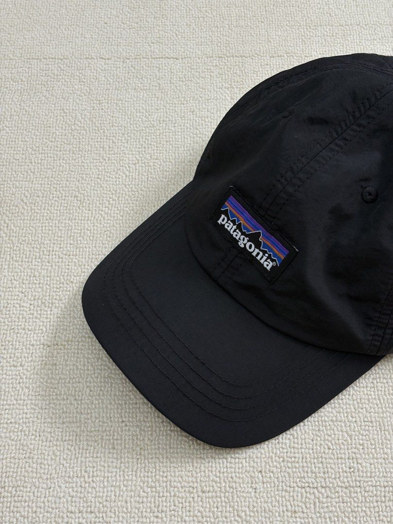 Patagonia Black Cap Nylon Hat (Category: Caps & Hats) located in Manila. Submitted by porma.market (Listing ID 1467404069, Image 1). Description: - 100% lightweight and quick-drying nylon material - Classic woven logo patch on the structured front panel - Breathable mesh lining for all-day comfort - Adjustable strap closure for a customizable fit - Ideal for hiking, running errands, or casual everyday wear.