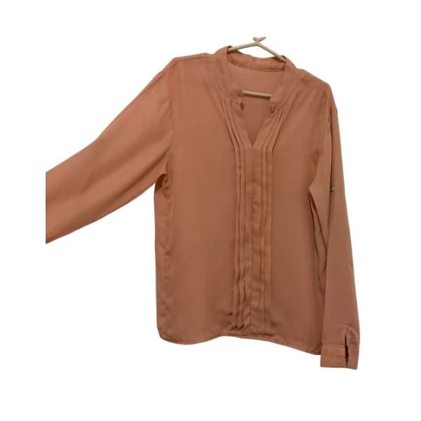 Peach Long Sleeve Pleated V-Neck Blouse (Category: Longsleeves) located in San Fernando. Submitted by lovingthings1 (Listing ID 1467391183, Image 3). Description: - Color: Peach - Style: Long sleeve blouse with V-neckline and vertical front pleating - Features: Button cuffs and tab sleeve details - Material: Lightweight and comfortable - Versatility: Perfect for classic workwear or casual pairing with jeans - Condition: Clean overall with minimal