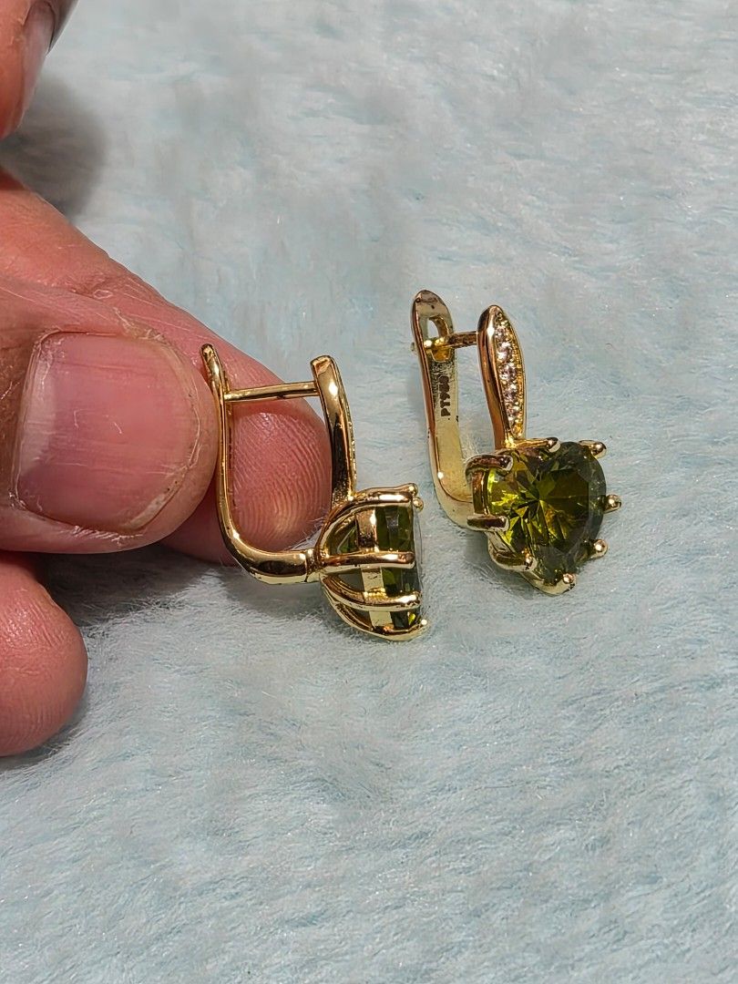 PERIDOT Crystal Heart Earrings Leverback (Category: Earrings) located in Mandaue City. Submitted by chuchi152615 (Listing ID 1467549735, Image 2). Description: - Gold-tone leverback earrings with large, faceted vibrant green heart stones - Accented with small sparkling cubic zirconia along the closure hoop - Features PT900 hallmark stamp on the inner clasp - Secure and comfortable closure mechanism - Clean metal finish, perfect for gifts or speci