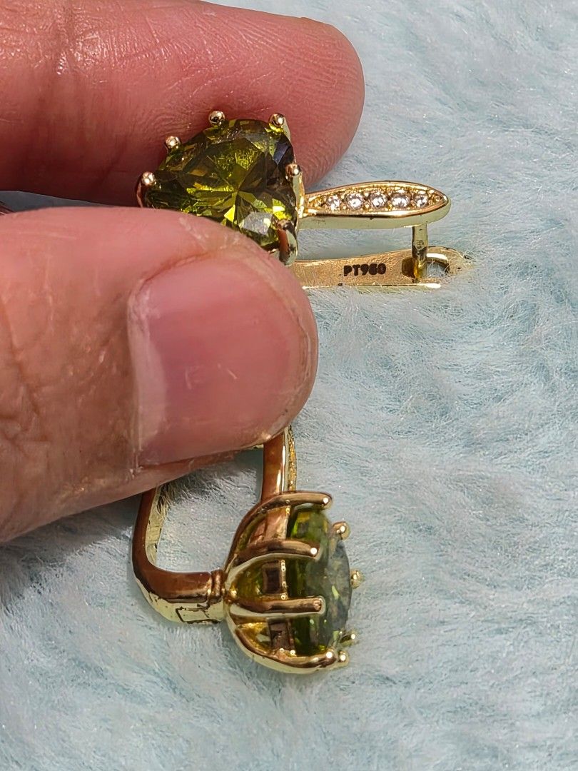 PERIDOT Crystal Heart Earrings Leverback (Category: Earrings) located in Mandaue City. Submitted by chuchi152615 (Listing ID 1467549735, Image 3). Description: - Gold-tone leverback earrings with large, faceted vibrant green heart stones - Accented with small sparkling cubic zirconia along the closure hoop - Features PT900 hallmark stamp on the inner clasp - Secure and comfortable closure mechanism - Clean metal finish, perfect for gifts or speci