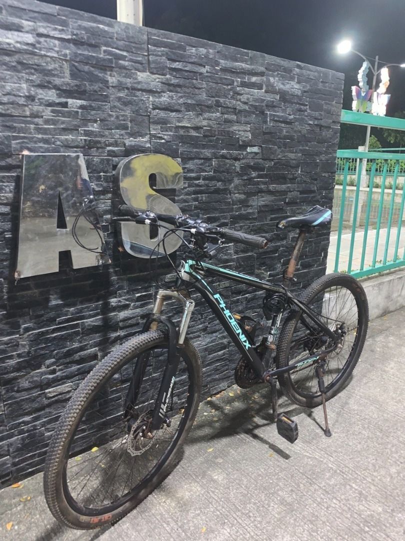 Phoenix Mountain Bike (Category: Bicycles) located in Dasmarinas. Submitted by irism7guel (Listing ID 1467503159, Image 1). Description: Fast sale (para mabenta agad) - Brand: Phoenix - Model: Hardtail MTB (SuperX / New Design) - Fork: FHS300 - 3×7 speed - Disc brakes - Black + teal/mint accents - Still working well, ready to ride. - second hand Freebies: - Bike tail red light - Bottle cage - Bicycle phone holder (Willing to negotiate. pick-up on