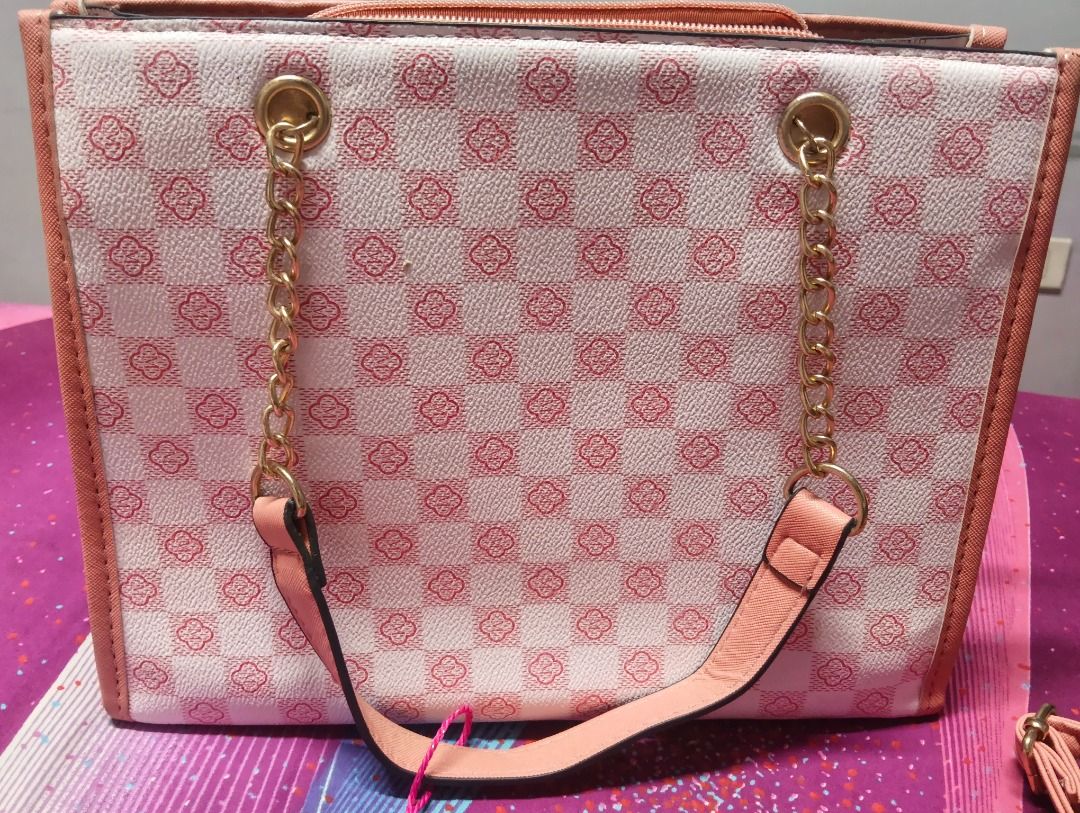 Pink and White Patterned Tote Bag with Chain Straps (Category: Shoulder Bags) located in Antipolo. Submitted by jocyong22 (Listing ID 1467520100, Image 2). Description: - Trendy pink and white checkered pattern with solid pink top trim - Elegant gold 'B' logo hardware centerpiece - Dual handles featuring a mix of gold-tone chain and pink strap - Secure zippered main compartment with a center zip divider pocket and black lining - Spacious interior