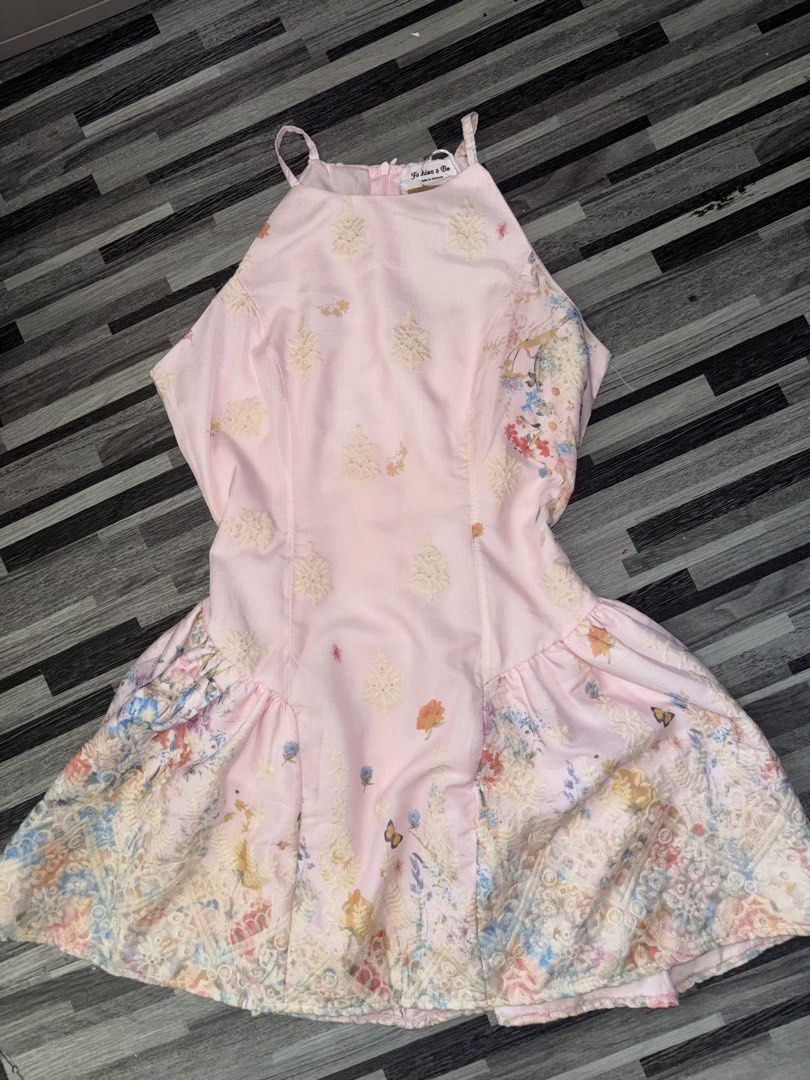 Pink Halter Floral Dress Size Medium (Category: Dresses) located in Caloocan City. Submitted by niki.niki. (Listing ID 1467504047, Image 2). Description: - Condition: Brand new with tag still attached - Color: Pink (Yellow version also available) - Size: Medium (fits bust 36 inches) - Design: Halter neck, delicate floral print, and butterfly motifs with a structured flare skirt - Fit & Comfort: Fully lined with built-in inner shorts, smocked back