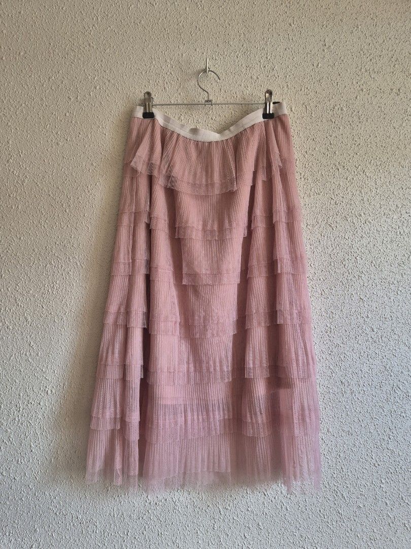Pink Layered Midi Skirt (Category: Skirts) located in Manila. Submitted by belovedbyjess (Listing ID 1467408365, Image 2). Description: - Color: Pink - Style: Midi skirt with layered ruffled tulle and a pretty tiered design - Waist: Elastic, stretches from 28 to 42 inches for a comfortable fit - Length: 27 inches - Fabric: Super flowy material - Versatility: Great for casual days or dressed up for special occasions.