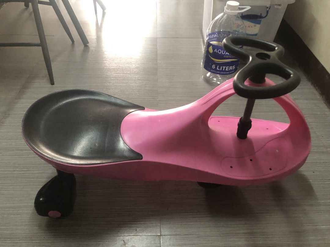 Pink twist car for kids (Category: Kids Toys) located in Cavite. Submitted by ai__chang (Listing ID 1467462456, Image 3). Description: - Heavy duty. Kaya kahit matanda ang sumakay. - Color: Pink and black - Smooth-rolling wheels for indoor and outdoor fun - Easy-to-use steering wheel setup for toddlers - Shows normal signs of use on plastic and wheels - Structurally solid and ready for the next child to enjoy.