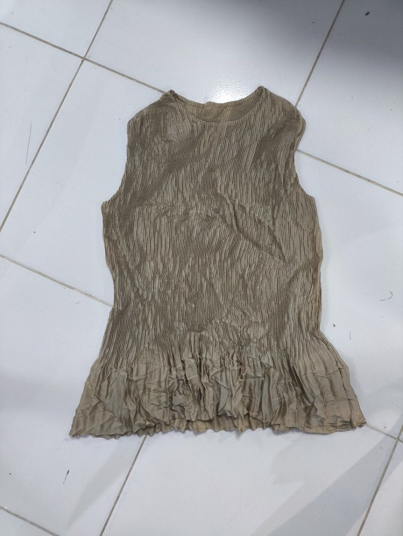 Pleatsme Plus Pleated Sleeveless Top (Category: Sleeveless) located in Manila. Submitted by maryaganda (Listing ID 1467377358, Image 1). Description: - Brand: Pleatsme - Color: Beige - Style: Sleeveless top with round neckline and ruffled hem - Design: All-over pleated fabric - Material: 100% polyester - Care: Hand wash only - Condition/Details: Manufactured in August 2020, lightweight and stylish.