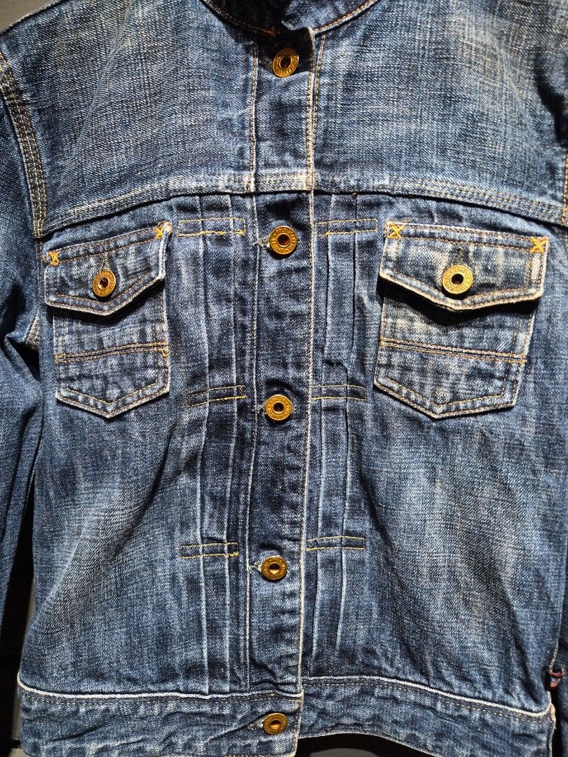 Polo Jeans Co. RL 1967 Denim Jacket (Category: Coats, Jackets and Outerwear) located in Davao. Submitted by rodrigoani57168 (Listing ID 1467370256, Image 3). Description: - Brand: Polo Jeans Co. RL 1967 - Wash: Heavy vintage dark wash with contrast yellow stitching - Details: Structured stand-up collar, button-front closure, dual chest flap pockets - Special Feature: Iconic American flag tag near the bottom hem - Hardware: Polo Jeans Co. branded 