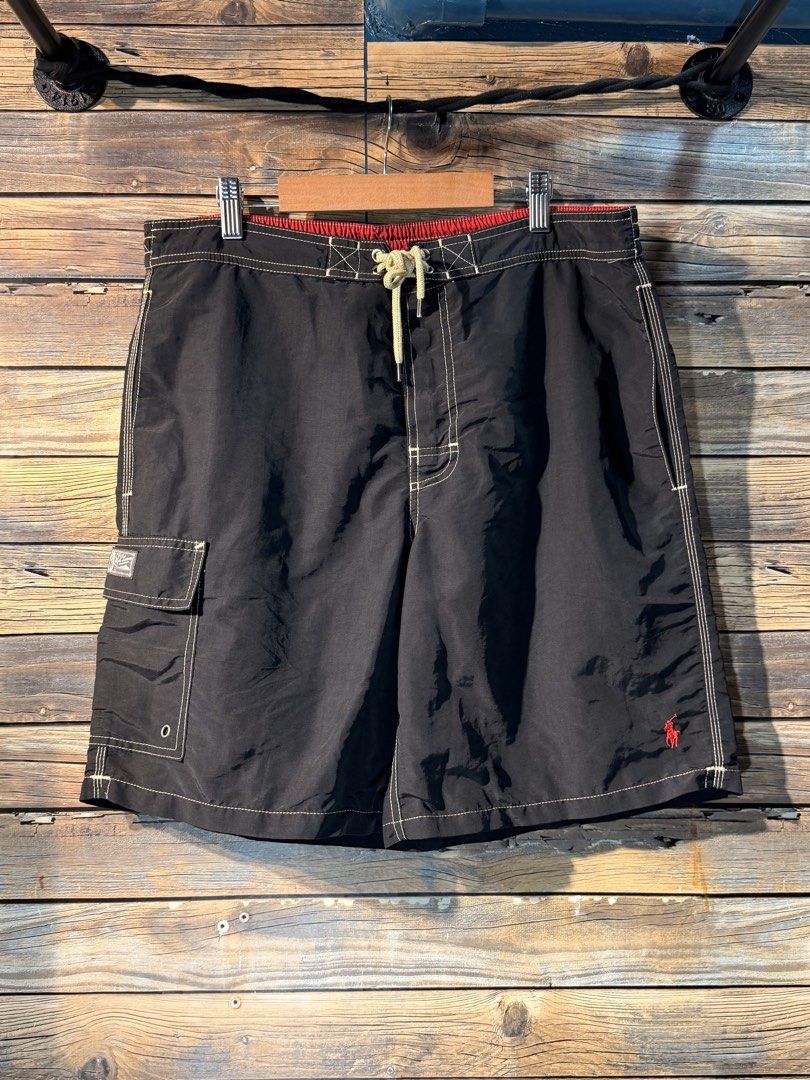 Polo Ralph Lauren Black Swim Trunks Medium (Category: Swim Trunks & Board Shorts) located in Catarman. Submitted by mightywater.d4516c (Listing ID 1467402453, Image 1). Description: - Very good condition - Dimes 34x19 - Brand: Polo Ralph Lauren - Size: Medium - Color: Black with contrast red waistband and white drawstring - Details: Signature red embroidered pony logo, side cargo pocket with grommets and branded patch - Condition: Good overall co