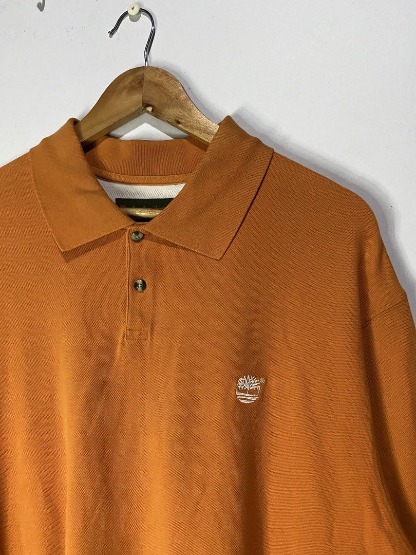 POLOSHIRT (Category: Tshirts & Polo Shirts ) located in Jaen. Submitted by oshimamark58418 (Listing ID 1467517503, Image 3). Description: - Brand: Timberland - Color: Vibrant Orange - Size: XL (Tagged 25x30 / fits like 3XL) - Material: 100% Cotton, comfortable pique knit - Condition: Good pre-loved condition - Features: Classic button placket and embroidered Timberland tree logo on chest.