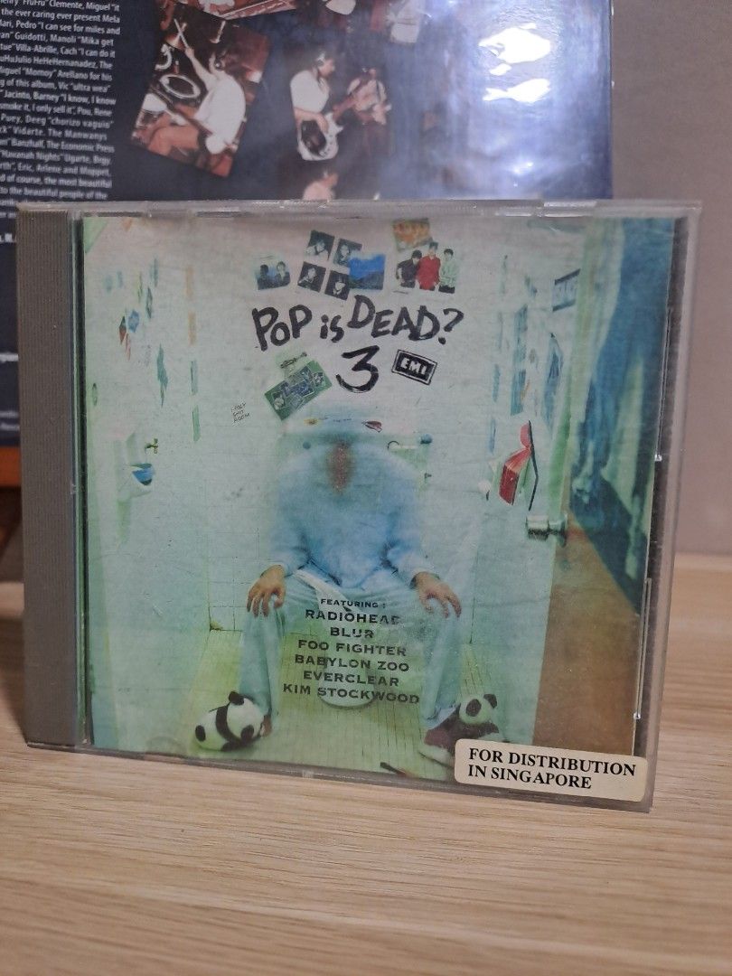 Pop is Dead? 3 Compilation Audio CD Album (Category: CDs & DVDs) located in Las Pinas. Submitted by cobieshop (Listing ID 1467488474, Image 1). Description: Pop is Dead? 3 compilation album on compact disc. EMI release featuring tracks from Radiohead, Blur, Foo Fighters, Babylon Zoo, Everclear, and Kim Stockwood. Includes a sticker on the case top right corner indicating distribution in Singapore. Standard jewel case packaging..