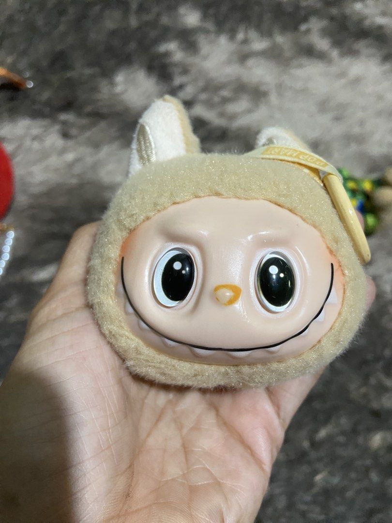 POP MART Labubu Monster plush pendant keychain (Category: Plushies & Soft Toys) located in Davao. Submitted by mengsmixitems (Listing ID 1467388303, Image 2). Description: - Authentic Pop Mart Labubu plush keychain - Color: Beige with signature vinyl face and mischievous smile - Includes original steel ring attachment and small Pop Mart tag - Compact and versatile, perfect for accessorizing bags or keys - 100% authentic, trusted seller with fast 