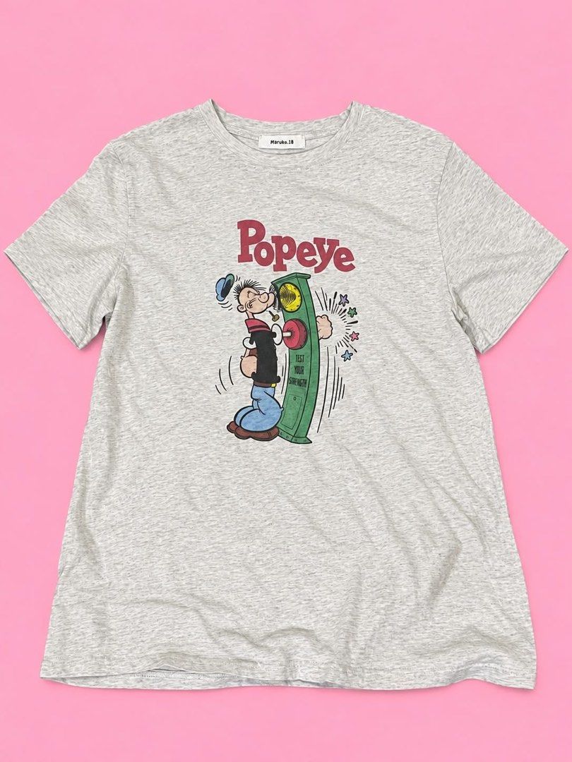 Popeye Graphic T-Shirt Grey (Category: Shirts) located in Manila. Submitted by chelle_thrifted_shack (Listing ID 1467491921, Image 1). Description: - Color: Light Grey - Brand/Style: Maruko.18 Crewneck T-Shirt - Design: Large vintage-style Popeye graphic with red lettering on the front - Fit: Regular fit with short sleeves - Material: Soft and comfortable cotton-blend fabric - Condition: good condition / Great for casual everyday wear.