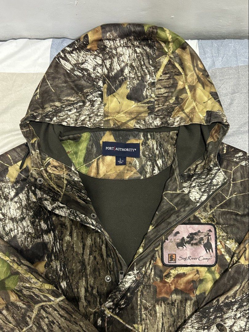 Port Authority | Camouflage Hooded Jacket (Category: Coats, Jackets and Outerwear) located in Balanga. Submitted by thrifted.btn (Listing ID 1467402968, Image 2). Description: [L] Port Authority Camo Hooded Jacket Brand: Port Authority Size: Large (L) Design: Heavyweight RealTree style camouflage with custom “Sag River Camp” chest patch.