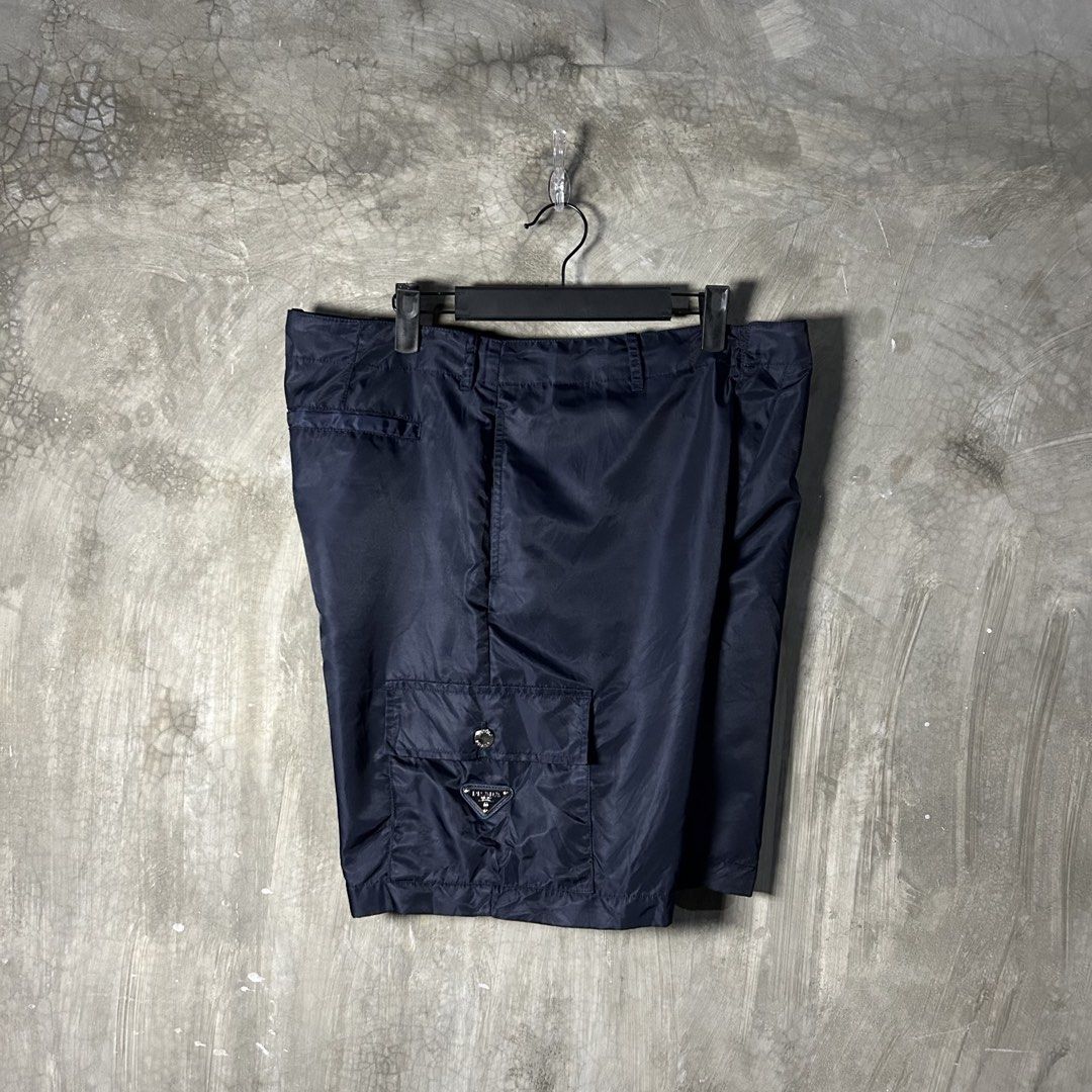 Prada - Re-Nylon Navy Cargo Short (Category: Luxury Apparel) located in Tayabas. Submitted by streetdepartment (Listing ID 1467545478, Image 2). Description: Prada - Re-Nylon Navy Cargo Short Good condition Flaw/s: loose stitching (kindly check pics for references) Size: 48 on tag Measurements (inches): Waist: 35-36” Length: 19.5” Leg opening: 11.5” Dm to purchase! Note: Manage your expectations as you are dealing with secondhand items. Color may