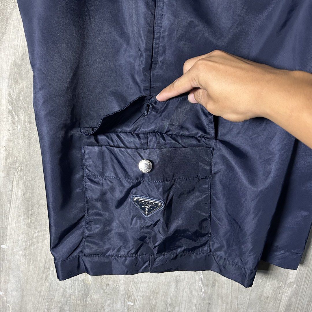 Prada - Re-Nylon Navy Cargo Short (Category: Luxury Apparel) located in Tayabas. Submitted by streetdepartment (Listing ID 1467545478, Image 3). Description: Prada - Re-Nylon Navy Cargo Short Good condition Flaw/s: loose stitching (kindly check pics for references) Size: 48 on tag Measurements (inches): Waist: 35-36” Length: 19.5” Leg opening: 11.5” Dm to purchase! Note: Manage your expectations as you are dealing with secondhand items. Color may