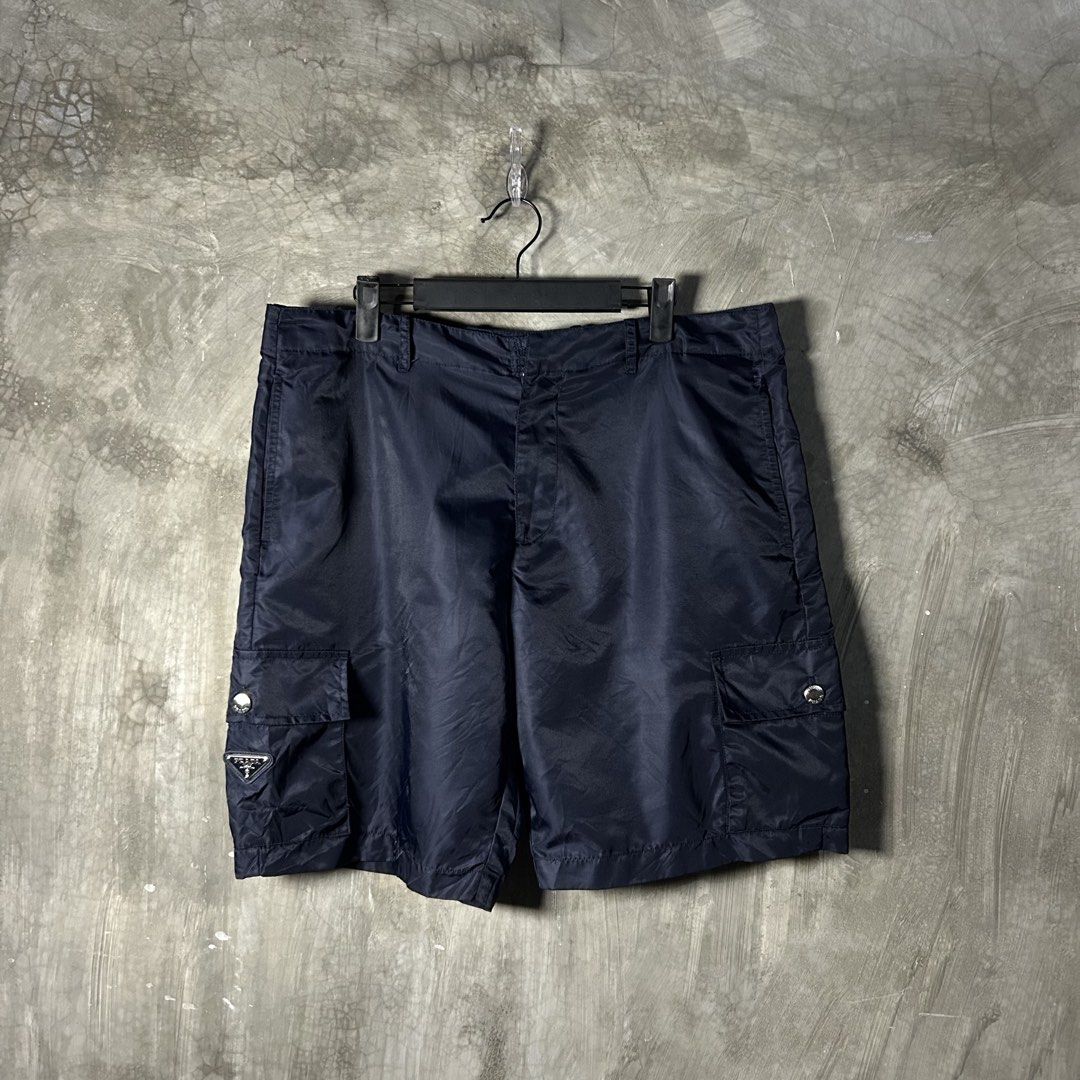 Prada - Re-Nylon Navy Cargo Short (Category: Luxury Apparel) located in Tayabas. Submitted by streetdepartment (Listing ID 1467545478, Image 1). Description: Prada - Re-Nylon Navy Cargo Short Good condition Flaw/s: loose stitching (kindly check pics for references) Size: 48 on tag Measurements (inches): Waist: 35-36” Length: 19.5” Leg opening: 11.5” Dm to purchase! Note: Manage your expectations as you are dealing with secondhand items. Color may