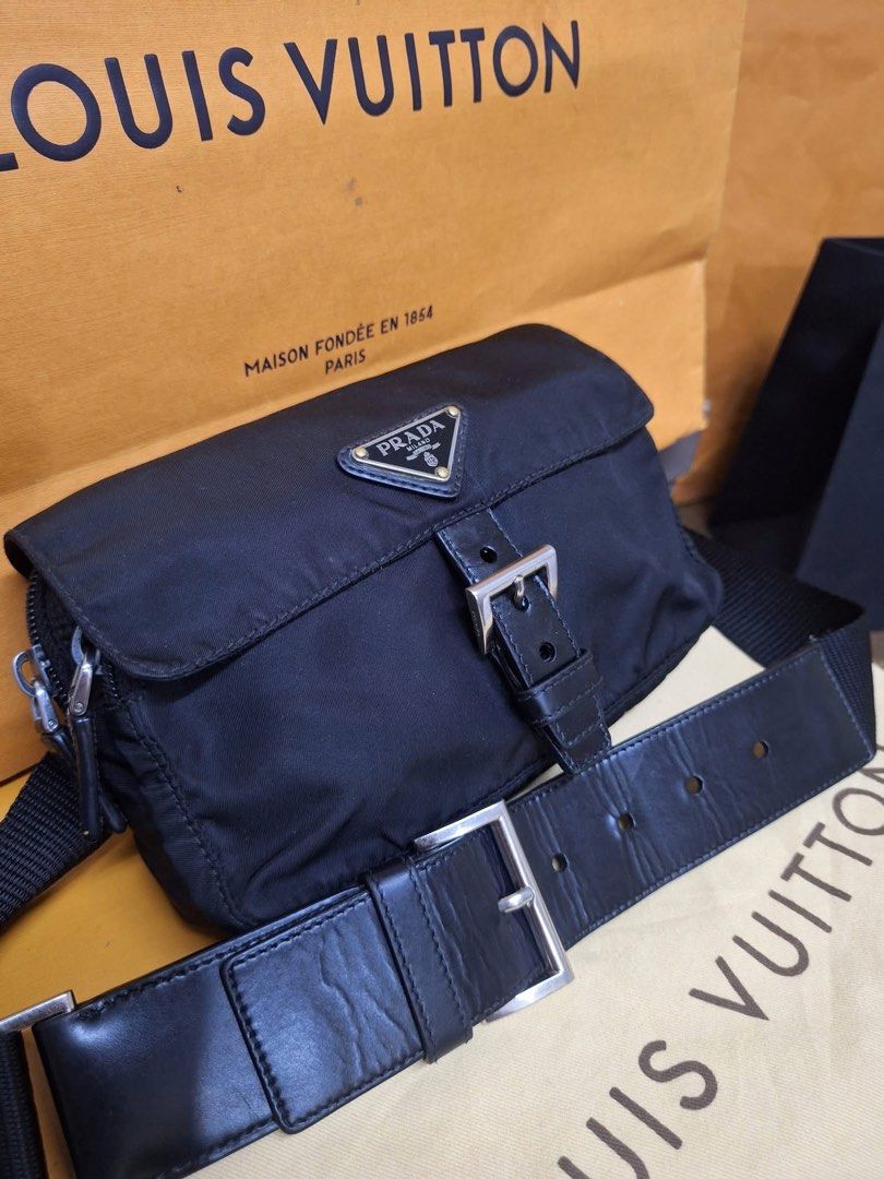 Prada Black Nylon belt bag (Category: Luxury Bags & Wallets) located in Dagupan City. Submitted by makilux.ph (Listing ID 1467377550, Image 3). Description: - Brand: Prada - Material: Durable black nylon with leather trim - Hardware: Silver-tone - Closure: Front flap with leather buckle strap - Logo: Iconic triangular metal logo plaque - Strap: Adjustable heavy-duty black canvas strap with leather accent - Size: Compact and practical for everyday
