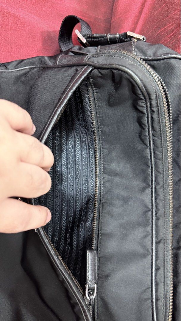 Prada Black Nylon Messenger Bag (Category: Luxury Bags & Wallets) located in Caloocan City. Submitted by prof_music1979 (Listing ID 1466712788, Image 3). Description: - Authentic Prada black nylon messenger bag - Iconic metal triangular logo plaque on the front pocket - Durable zip-around closure with sturdy metal zippers - Adjustable shoulder strap for a comfortable, custom fit - Interior lined with signature Prada jacquard fabric - Built-in zip