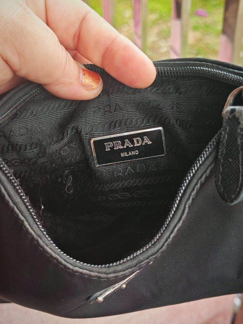 Prada Black Nylon Mini Shoulder Bag (Category: Luxury Bags & Wallets) located in Manila. Submitted by cleverwhale_45b7bc (Listing ID 1467377135, Image 2). Description: - Prada mini shoulder bag in classic black nylon - Features the iconic triangular logo plaque on the front - Secure top zip closure with sleek silver-tone hardware - Interior lined with signature Prada logo fabric and Milano metal plaque - Compact and lightweight design, perfect fo