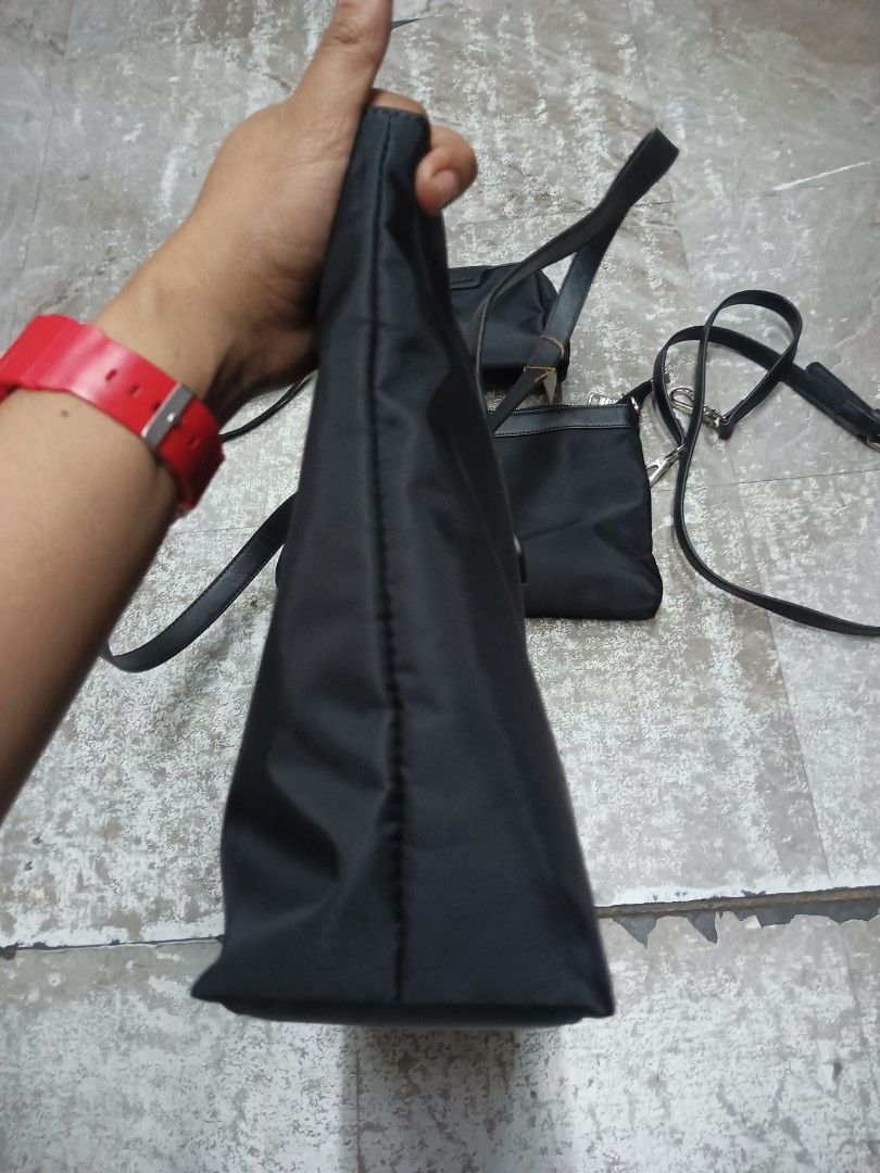 Prada Black Nylon Multi-Piece Tote Bag Set (Category: Luxury Bags & Wallets) located in Baguio. Submitted by brandeditems16 (Listing ID 1467583661, Image 2). Description: - Authentic Black Prada nylon 3-piece bundle - Set includes: Large tote bag, medium shoulder bag (with handles and strap), and small pouch with wrist strap - Features iconic metal triangle logo plaque on each piece - Crafted from durable, lightweight signature nylon fabric with 