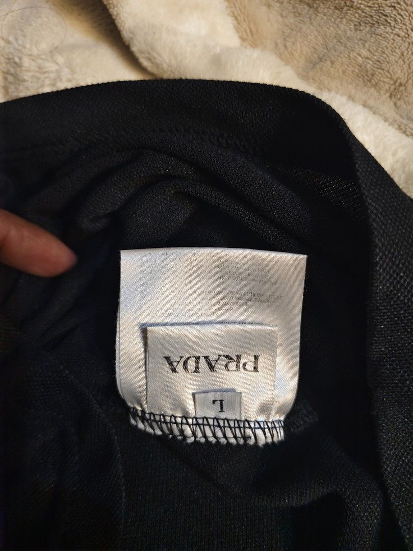 Prada Black Polo Shirt Size L (Category: Tshirts & Polo Shirts ) located in Bayugan. Submitted by boss_rej (Listing ID 1467525727, Image 3). Description: - Brand: Prada - Item: Polo Shirt - Color: Black - Size: L - Condition: Brand new with tags attached - Details: Iconic triangle logo plaque on the left chest, classic collar, and button placket - Style: Versatile staple for casual or smart-casual outfits - Shipping or meetups available across th