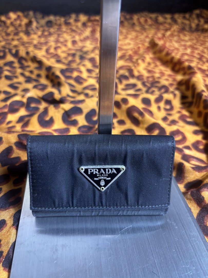 Prada Nylon 6 key holder (Category: Wallets & Card Holders) located in Manila. Submitted by earlylifecrisis3 (Listing ID 1467461434, Image 1). Description: Missing One key holder Condition 8.5/10 Measure it by inch Width: 4 Length: 2.5 Depth: 1 Handle: 0 •Refund / Returns not allowed allowed •Please do check the dimensions size on labels sometimes are not accurate on the sizing •Ask me before purchasing.