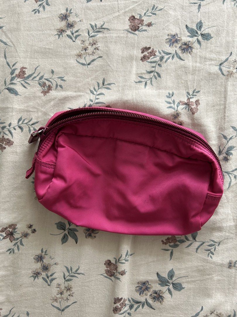 Prada Nylon Pink Cosmetic Pouch (Category: Purses & Pouches) located in Manila. Submitted by ashleyrosedg (Listing ID 1467389986, Image 3). Description: - Brand: Prada - Color: Bright pink - Material: Durable nylon with Saffiano leather trim - Closure: Top zipper closure with matching pink lining - Details: Iconic triangle logo plaque on the front and interior leather tag - Usage: Compact size, ideal for daily essentials, makeup, or travel organi