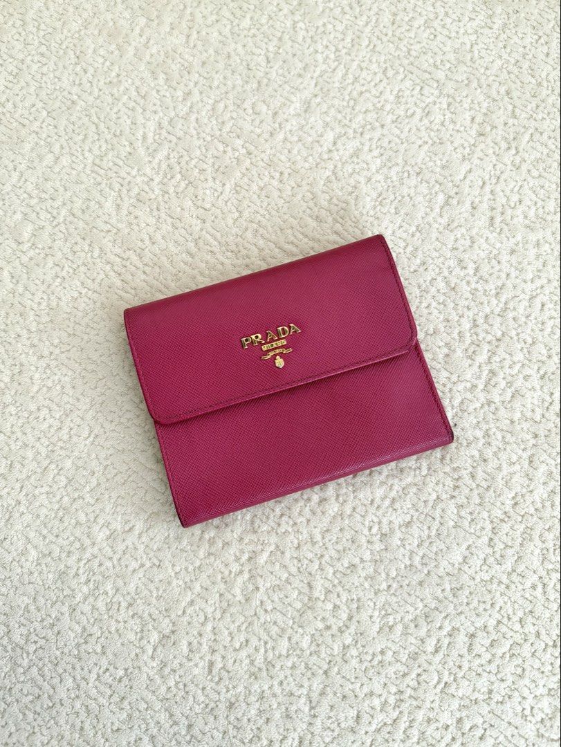 Prada Pink Saffiano Short Wallet (Category: Luxury Bags & Wallets) located in Paranaque City. Submitted by consciouscleanout (Listing ID 1367558612, Image 1). Description: Bought secondhand in Japan Comes as is. No box or dust bag but can include a generic one 9/10 condition, with very minimal wear and tear Read before making an offer! - All photos posted. No when worns or extra measurements unless already included in the listing. Please use your