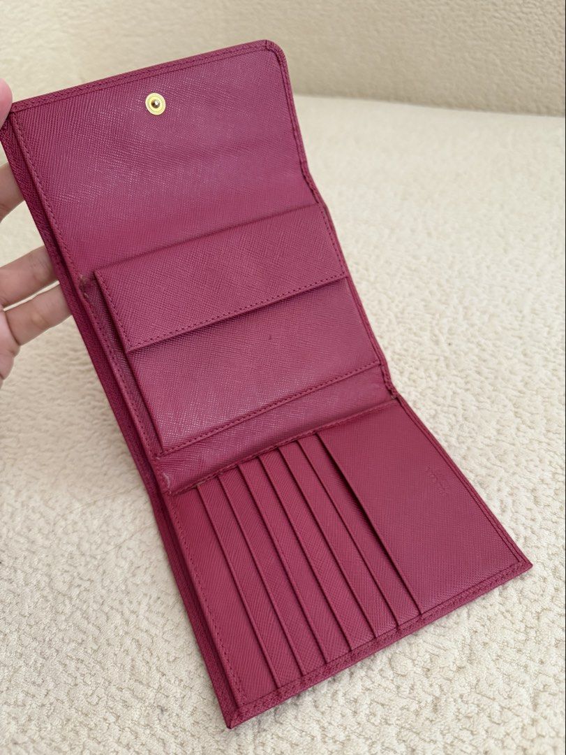 Prada Pink Saffiano Short Wallet (Category: Luxury Bags & Wallets) located in Paranaque City. Submitted by consciouscleanout (Listing ID 1367558612, Image 3). Description: Bought secondhand in Japan Comes as is. No box or dust bag but can include a generic one 9/10 condition, with very minimal wear and tear Read before making an offer! - All photos posted. No when worns or extra measurements unless already included in the listing. Please use your
