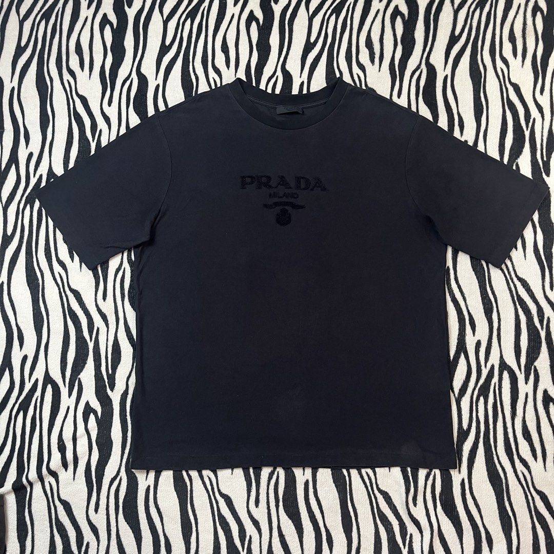 Prada tshirt script design (Category: Luxury Apparel) located in Manila. Submitted by royaldripmanila (Listing ID 1467375416, Image 1). Description: Good condition 9/10 W23 L28.