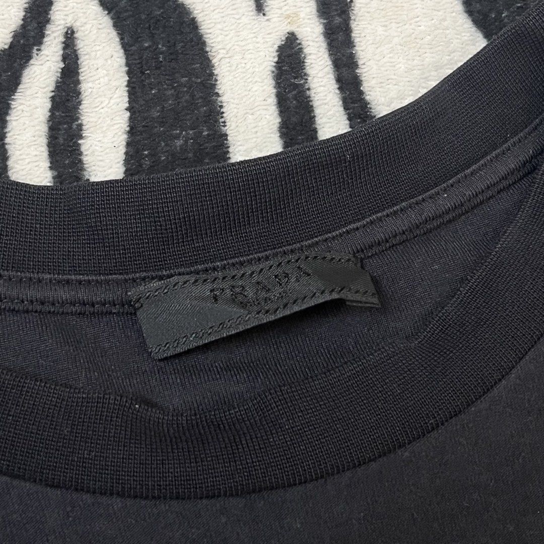 Prada tshirt script design (Category: Luxury Apparel) located in Manila. Submitted by royaldripmanila (Listing ID 1467375416, Image 2). Description: Good condition 9/10 W23 L28.