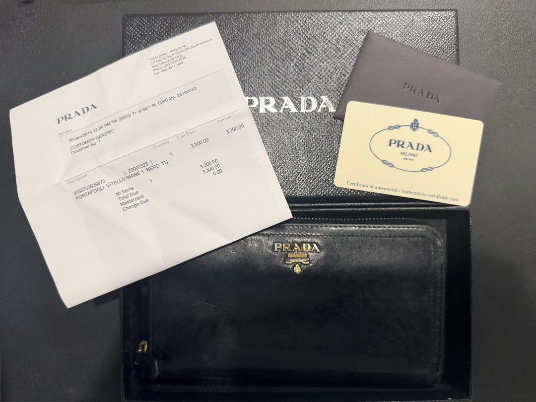 Authentic Prada Vitello Shine Zip Around Wallet Black (Category: Luxury Bags & Wallets) located in Paranaque City. Submitted by silverforest.13 (Listing ID 1467363642, Image 2). Description: - Authentic Prada long zip-around wallet (Model 1M0506) - Material: Luxurious black Vitello Shine leather with gold hardware lettering - Condition: Clean interior and smooth, fully functional zipper - Inclusions: Original box, authenticity card, and store rec