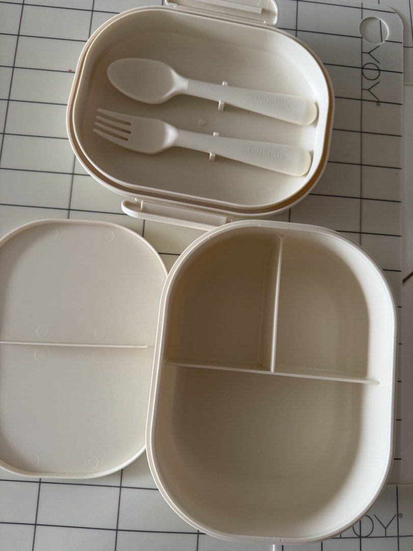 Preloved Mushie Bento Box with Fork and Spoon (Category: Food Organization & Storage) located in Manila. Submitted by helloseptembermnl (Listing ID 1467364615, Image 1). Description: - Authentic Mushie Lunch Box (Made in Denmark) - Color: Cream - Includes matching spoon and fork that securely clip into the lid - 3 divided compartments to keep foods separate - Microwave safe up to 100°C (for reheating only, not cooking) - Practical bento-style des