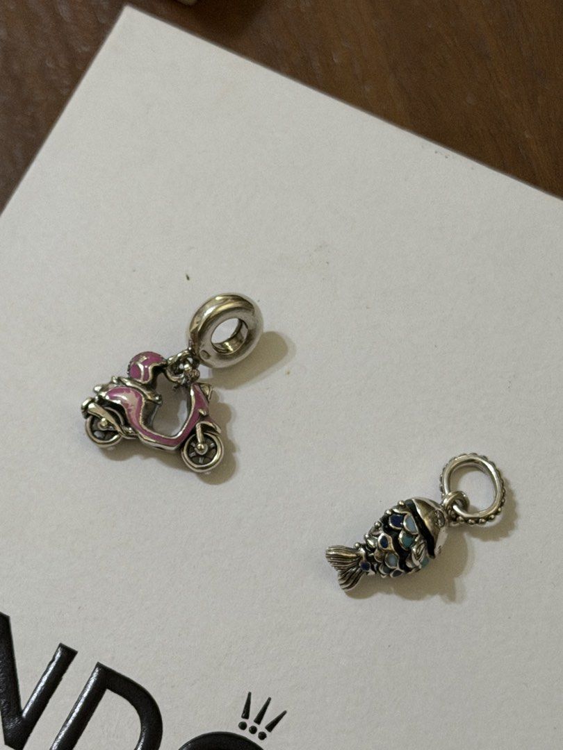 Preloved Pandora Charms (Category: Charms) located in Manila. Submitted by thekcollection (Listing ID 1467443420, Image 1). Description: AUTHENTIC PRELOVED PANDORA! 🛍️🛒 Pink retired murano charm - with signs of usage - 1250 Light blue -like new- 1450 Evil eye pink retired murano - minor signs of use - 1450 Sparkling pink murano- like new- 1450 Fish charm - like new - 1900 Scooter - like new - 2500 No inclusions! All preloved. 100% money back if