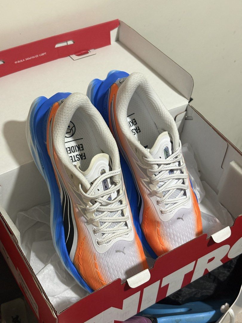 Puma Velocity Nitro 4 Ekiden Running Shoes (Category: Sneakers) located in San Fernando. Submitted by migyspreloved_ (Listing ID 1467461049, Image 2). Description: - Brand: Puma - Model: Velocity Nitro 3 (Ekiden Colorway) - Color: White, orange, and vibrant blue gradient - Condition: Brand new - Cushioning: Nitro foam midsole for ultimate comfort - Outsole: Pumagrip rubber for superior traction - Packaging: Complete with original Puma shoe box Is