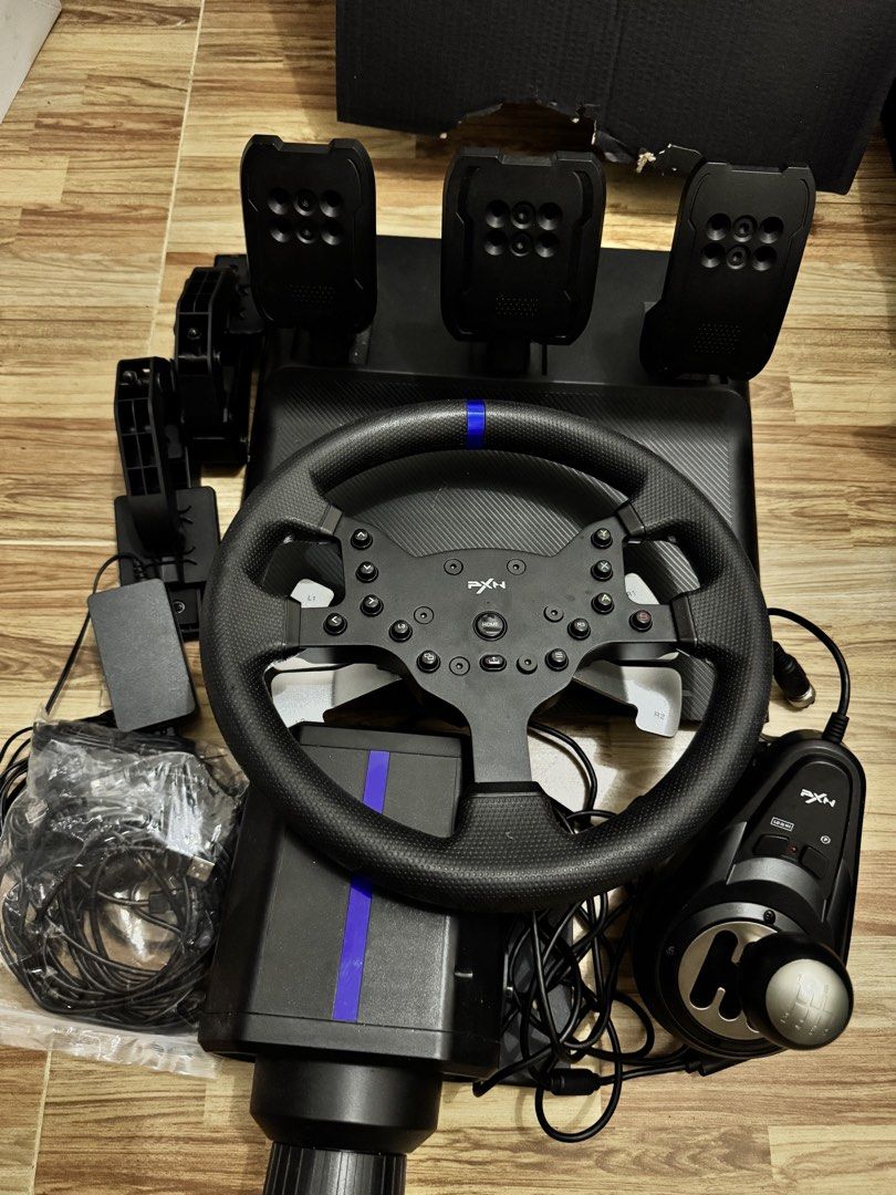 PXN V99 Racing Wheel Set (Category: Controllers) located in Manila. Submitted by chantyyy0325 (Listing ID 1467383221, Image 1). Description: Selling my PXN V9.9 Force Feedback Racing Wheel complete set. ✅ Racing wheel ✅ Force feedback ✅ 3-pedal set ✅ Gear shifter ✅ Great for racing games / sim racing ✅ Complete set ✅ Good condition 🎮 Perfect for racing enthusiasts looking to build their own sim racing setup. 📌 RFS: Rarely used / need Cash 💵 ₱9