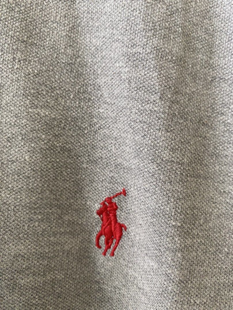 Ralph Lauren Grey Polo Shirt (Category: Tshirts & Polo Shirts ) located in Pandi. Submitted by nasya_thrift_collection2023 (Listing ID 1467413697, Image 2). Description: - Brand: Ralph Lauren - Color: Grey - Material: 100% Cotton (Made in China) - Features: Short sleeves, classic collar with 2 buttons, signature red embroidered pony logo on the chest - Condition: Clean fabric throughout, excellent pre-loved condition.