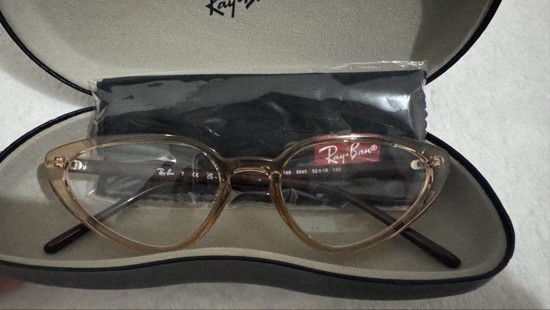 Ray-Ban Cat Eye Eyeglasses RB7188 (Category: Sunglasses & Eyewear) located in Legazpi City. Submitted by bellatorre (Listing ID 1467526849, Image 1). Description: - Brand: Ray-Ban - Style: Cat eye frames in a chic translucent brownish tone - Model details: 7188 - Lenses: Original clear demo lenses (ready for your graded or prescription lenses) - Condition: Brand new, never worn, pristine condition - Inclusions: Original Ray-Ban hard case and micr