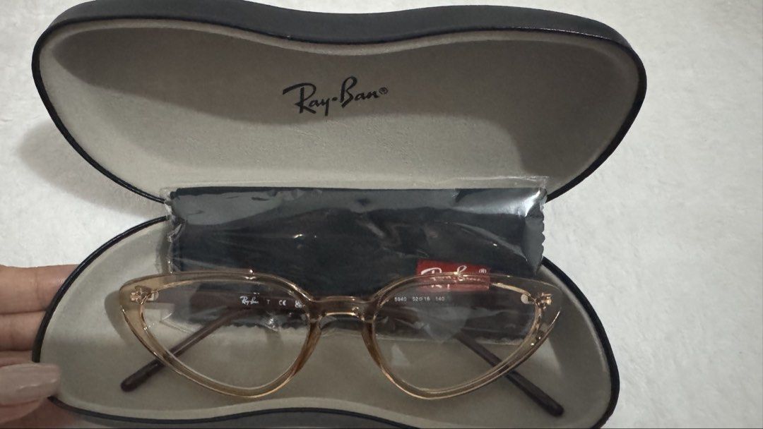 Ray-Ban Cat Eye Eyeglasses RB7188 (Category: Sunglasses & Eyewear) located in Legazpi City. Submitted by bellatorre (Listing ID 1467526849, Image 2). Description: - Brand: Ray-Ban - Style: Cat eye frames in a chic translucent brownish tone - Model details: 7188 - Lenses: Original clear demo lenses (ready for your graded or prescription lenses) - Condition: Brand new, never worn, pristine condition - Inclusions: Original Ray-Ban hard case and micr