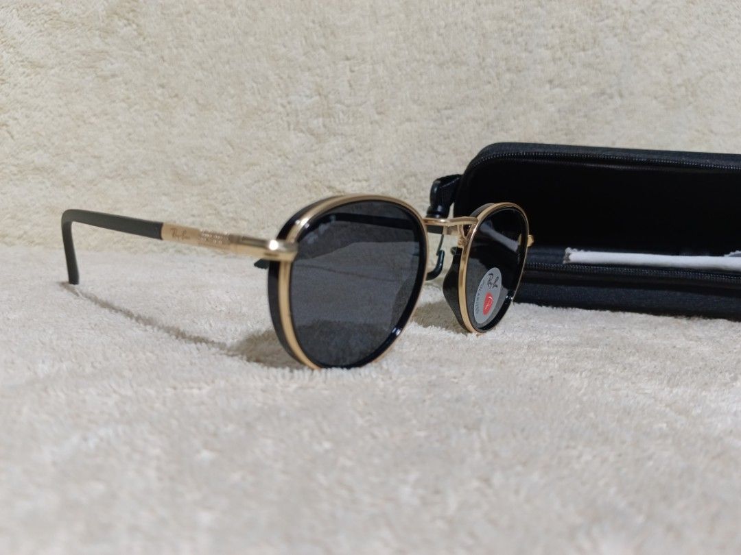 Ray-Ban Polarized Sunglasses Black Gold Round Frames (Category: Sunglasses & Eyewear) located in Cavite. Submitted by navias (Listing ID 1467547179, Image 2). Description: - Brand: Ray-Ban - Frame: Black and gold round frames with textured gold temples - Lenses: Polarized dark lenses with Ray-Ban logo - Origin: Made in Italy - Inclusions: Black zippered hard case and cleaning cloth - Condition: Excellent.