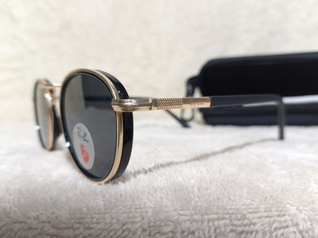 Ray-Ban Polarized Sunglasses Black Gold Round Frames (Category: Sunglasses & Eyewear) located in Cavite. Submitted by navias (Listing ID 1467547179, Image 3). Description: - Brand: Ray-Ban - Frame: Black and gold round frames with textured gold temples - Lenses: Polarized dark lenses with Ray-Ban logo - Origin: Made in Italy - Inclusions: Black zippered hard case and cleaning cloth - Condition: Excellent.