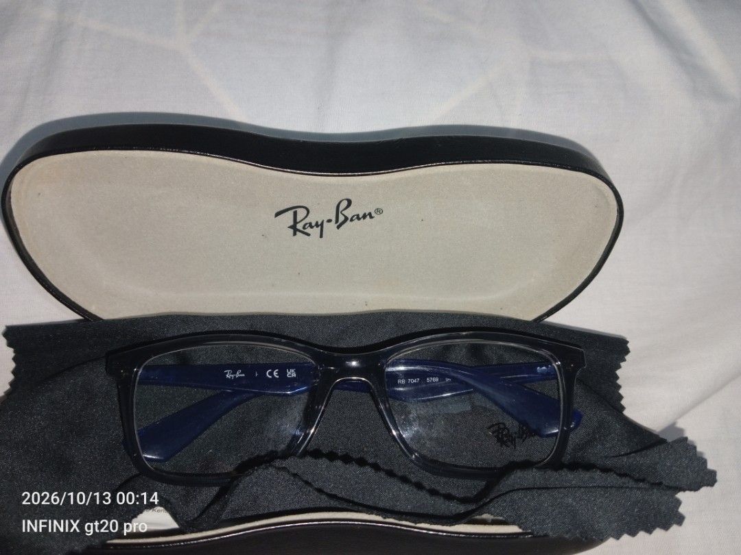Ray-Ban RB 7047 Glasses (Category: Sunglasses & Eyewear) located in Manila. Submitted by vonguiller59747 (Listing ID 1467560338, Image 3). Description: - Authentic Ray-Ban optical frames (Model: RB 7047 5769) - Stylish dark translucent grey front with striking deep blue temples - Signature Ray-Ban logo lettering on the arms - Fitted with standard clear demo lenses (ready for your custom prescription) - Includes original branded hard case and micr