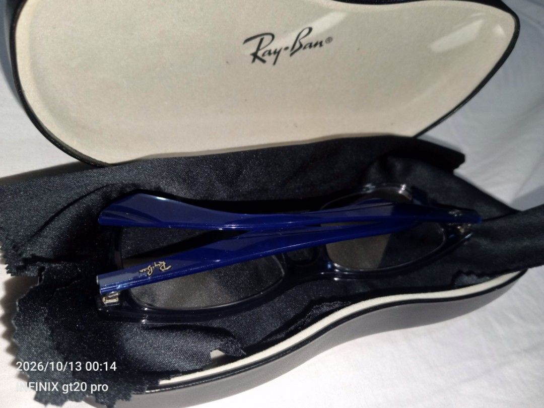 Ray-Ban RB 7047 Glasses (Category: Sunglasses & Eyewear) located in Manila. Submitted by vonguiller59747 (Listing ID 1467560338, Image 1). Description: - Authentic Ray-Ban optical frames (Model: RB 7047 5769) - Stylish dark translucent grey front with striking deep blue temples - Signature Ray-Ban logo lettering on the arms - Fitted with standard clear demo lenses (ready for your custom prescription) - Includes original branded hard case and micr