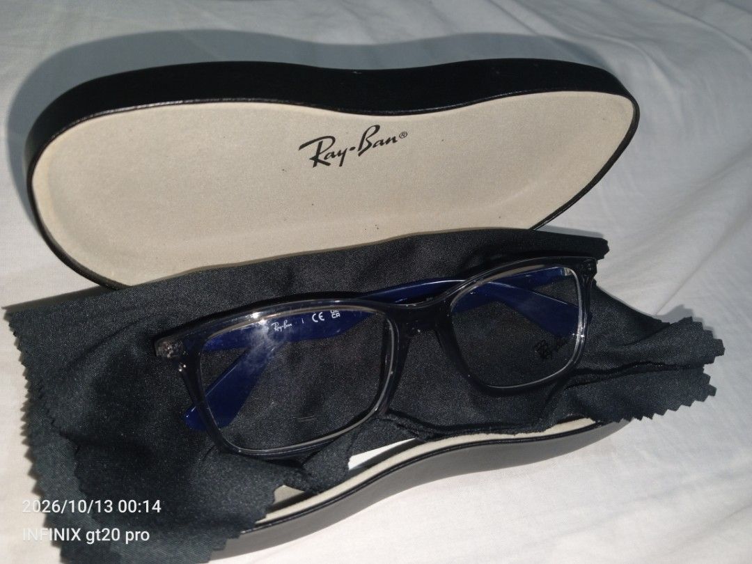 Ray-Ban RB 7047 Glasses (Category: Sunglasses & Eyewear) located in Manila. Submitted by vonguiller59747 (Listing ID 1467560338, Image 2). Description: - Authentic Ray-Ban optical frames (Model: RB 7047 5769) - Stylish dark translucent grey front with striking deep blue temples - Signature Ray-Ban logo lettering on the arms - Fitted with standard clear demo lenses (ready for your custom prescription) - Includes original branded hard case and micr