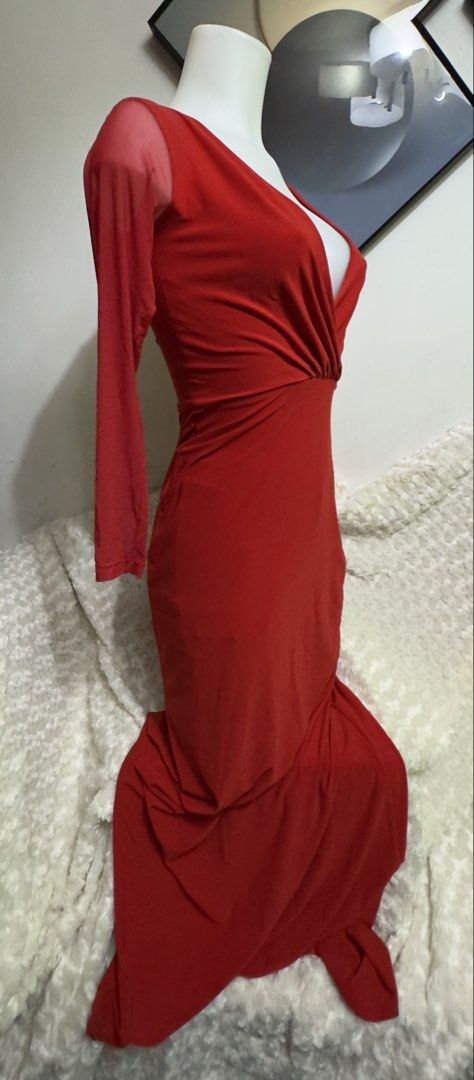 Red long sleeve maxi dress (Category: Dresses) located in Marikina City. Submitted by lorradel (Listing ID 1467508498, Image 2). Description: - Color: Bright red - Design: Sheer mesh sleeves with deep V-neckline and gathered crossover wrap bodice - Fit: Fitted waist with a draped floor-length skirt and slight flare - Back: Solid red fabric with a smooth, zip-free slip-on fit - Occasion: Ideal for evening parties, balls, and formal events - MAY HA
