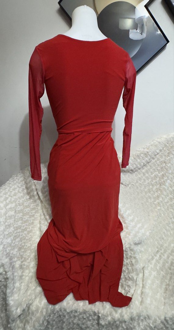 Red long sleeve maxi dress (Category: Dresses) located in Marikina City. Submitted by lorradel (Listing ID 1467508498, Image 3). Description: - Color: Bright red - Design: Sheer mesh sleeves with deep V-neckline and gathered crossover wrap bodice - Fit: Fitted waist with a draped floor-length skirt and slight flare - Back: Solid red fabric with a smooth, zip-free slip-on fit - Occasion: Ideal for evening parties, balls, and formal events - MAY HA