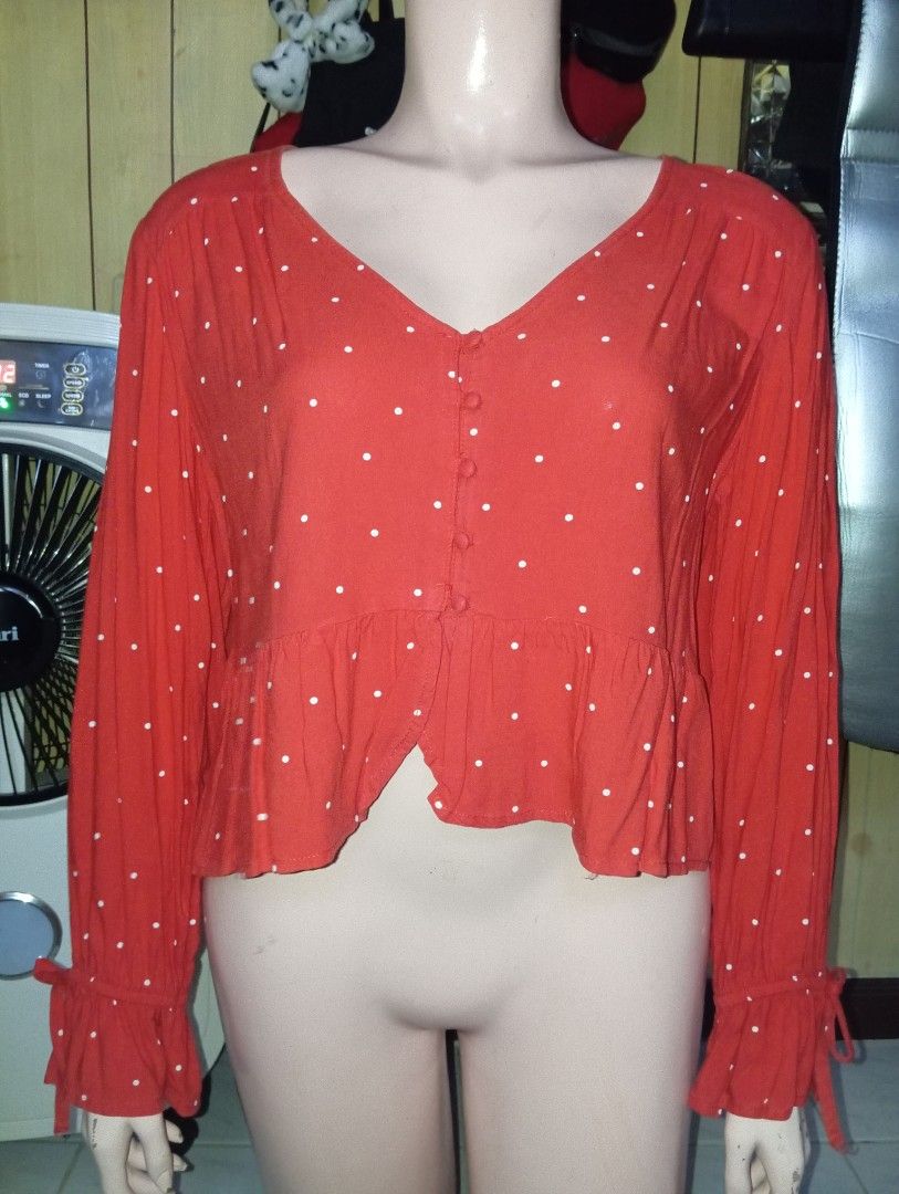 Red Polka Dot Long Sleeve Peplum Blouse (Category: Blouses) located in Cebu City. Submitted by smnthdanielle (Listing ID 1467378635, Image 2). Description: - Color & Pattern: Red with small white polka dots - Neckline: Deep V-neck with functional fabric buttons - Sleeves: Long sleeves with trendy ruffled cuffs and tie ribbons - Fit & Style: Cropped length with a flared peplum hem - Material: Lightweight, breathable fabric - Condition: Brand new /