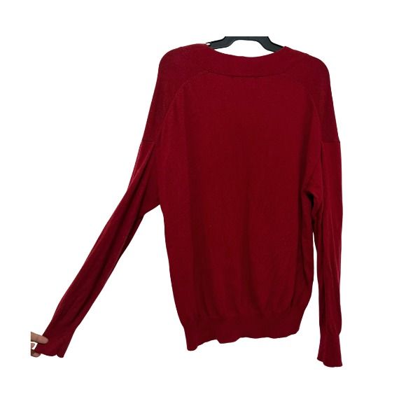 Red V-Neck Knit Sweater (Category: Coats, Jackets and Outerwear) located in San Fernando. Submitted by lovingthings1 (Listing ID 1467410396, Image 3). Description: - Color: Deep red - Neckline: Relaxed v-neck - Fit: Relaxed with drop shoulders - Sleeves: Long sleeves with ribbed cuffs - Material: Soft knitted fabric - Style: Clean back design, perfect for cooler weather.